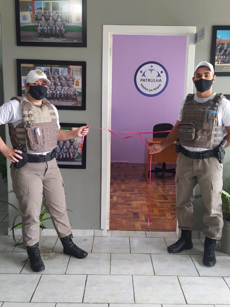 Policiais Militares desserando a fita de inaugura&ccedil;&atilde;o da sala.